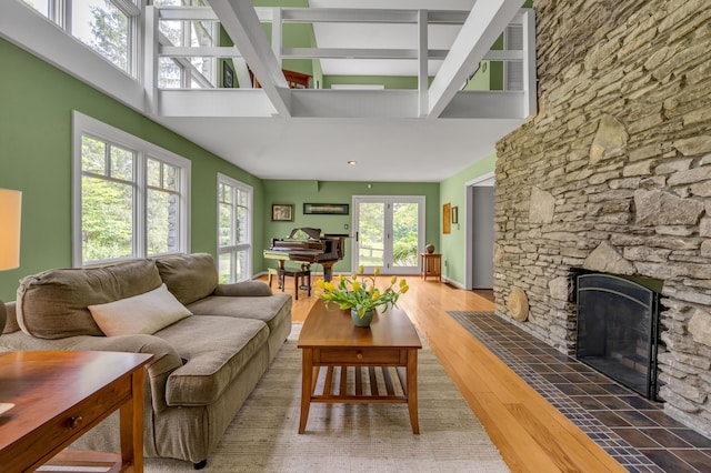 2968 Delong Rd, Lexington, KY 40515 - living area with a high ceiling, a stone fireplace, beam ceiling, and wood finished floors