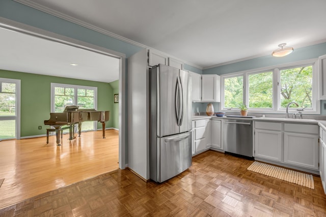 2968 Delong Rd, Lexington, KY 40515 - kitchen with stainless steel appliances, crown molding, white cabinetry, and light countertops