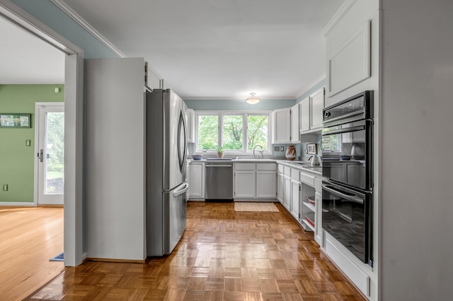 2968 Delong Rd, Lexington, KY 40515 - kitchen with appliances with stainless steel finishes, ornamental molding, white cabinetry, and light countertops