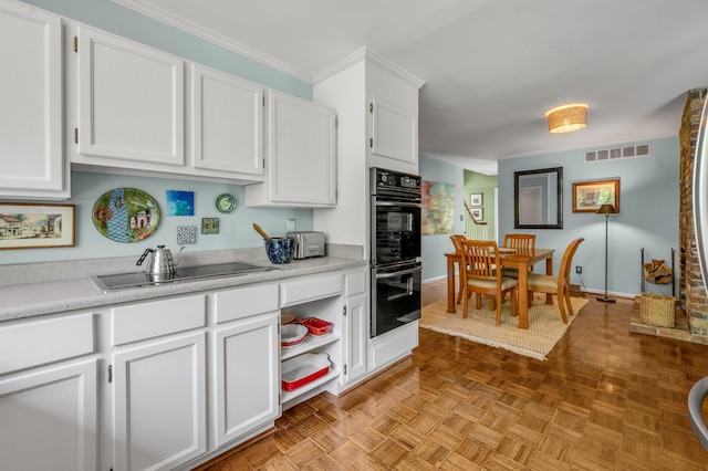 2968 Delong Rd, Lexington, KY 40515 - kitchen with black appliances, white cabinetry, light countertops, and crown molding