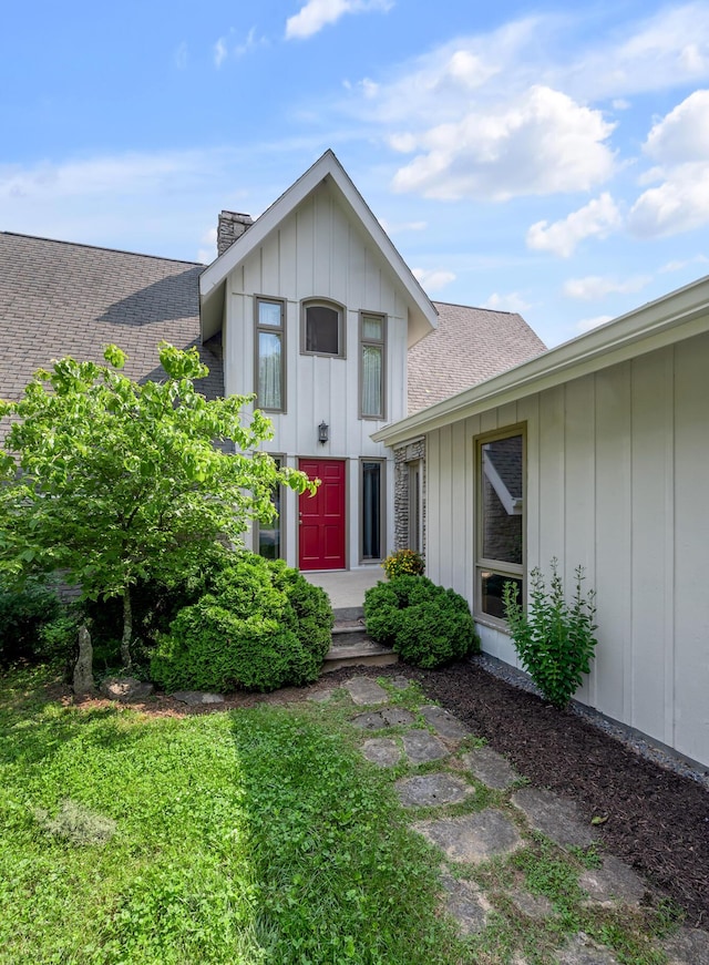 2968 Delong Rd, Lexington, KY 40515 - view of front of property featuring a shingled roof, a chimney, and board and batten siding