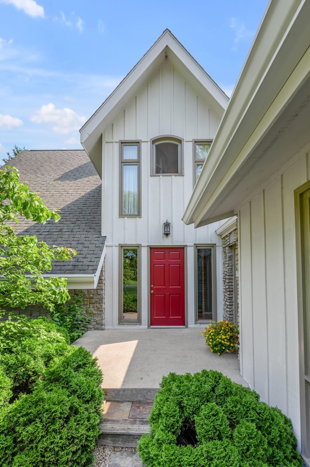 2968 Delong Rd, Lexington, KY 40515 - property entrance featuring board and batten siding, stone siding, and roof with shingles