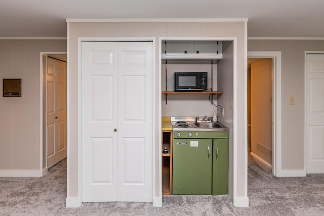 395 Redding Rd Unit 30, Lexington, KY 40517 - kitchen with black microwave, ornamental molding, carpet flooring, and light countertops