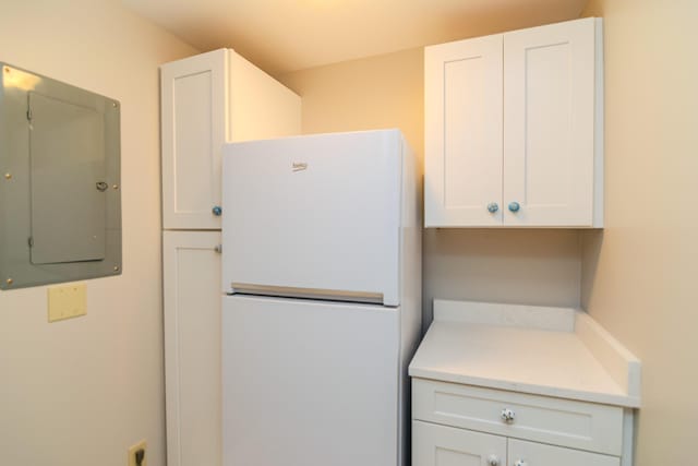 395 Redding Rd Unit 30, Lexington, KY 40517 - kitchen with freestanding refrigerator, electric panel, light countertops, and white cabinets