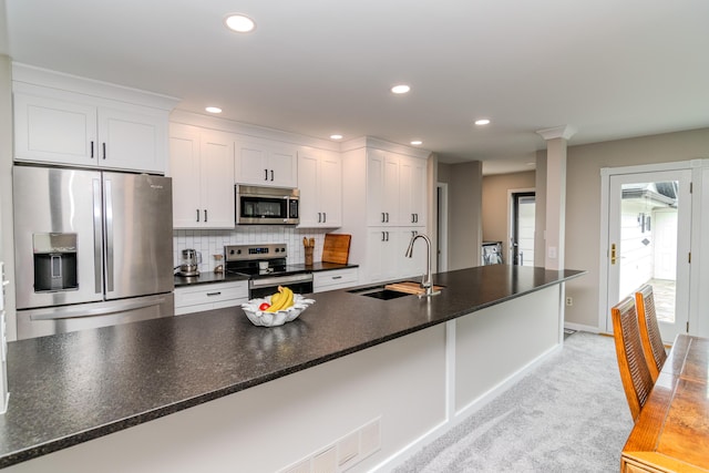 395 Redding Rd Unit 30, Lexington, KY 40517 - kitchen featuring stainless steel appliances, dark countertops, white cabinets, tasteful backsplash, and recessed lighting