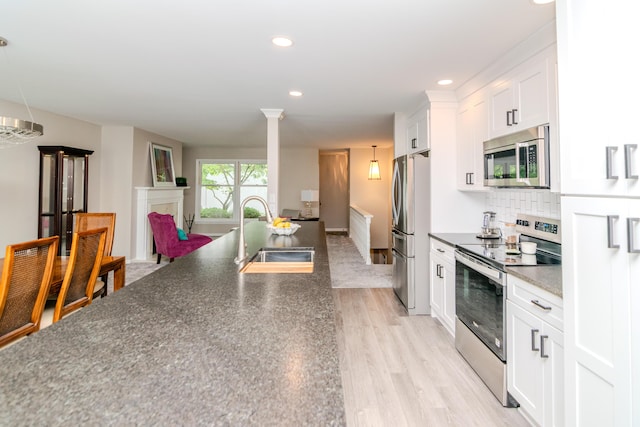 395 Redding Rd Unit 30, Lexington, KY 40517 - kitchen with appliances with stainless steel finishes, dark countertops, light wood-style flooring, white cabinets, and recessed lighting
