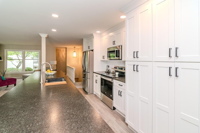 395 Redding Rd Unit 30, Lexington, KY 40517 - kitchen with stainless steel appliances, dark countertops, recessed lighting, white cabinets, and backsplash