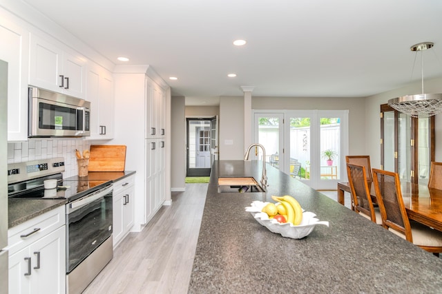 395 Redding Rd Unit 30, Lexington, KY 40517 - kitchen with appliances with stainless steel finishes, recessed lighting, white cabinets, backsplash, and light wood-type flooring