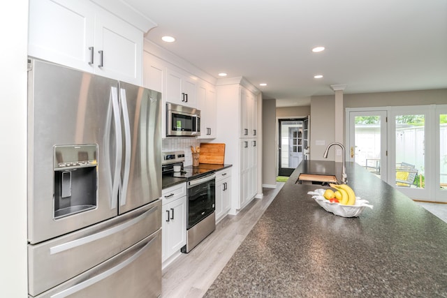 395 Redding Rd Unit 30, Lexington, KY 40517 - kitchen with stainless steel appliances, dark countertops, white cabinets, backsplash, and recessed lighting