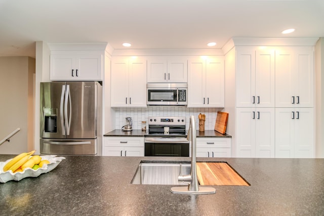 395 Redding Rd Unit 30, Lexington, KY 40517 - kitchen with stainless steel appliances, dark countertops, white cabinets, backsplash, and recessed lighting