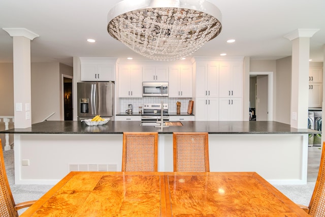395 Redding Rd Unit 30, Lexington, KY 40517 - kitchen with appliances with stainless steel finishes, decorative columns, dark countertops, backsplash, and recessed lighting