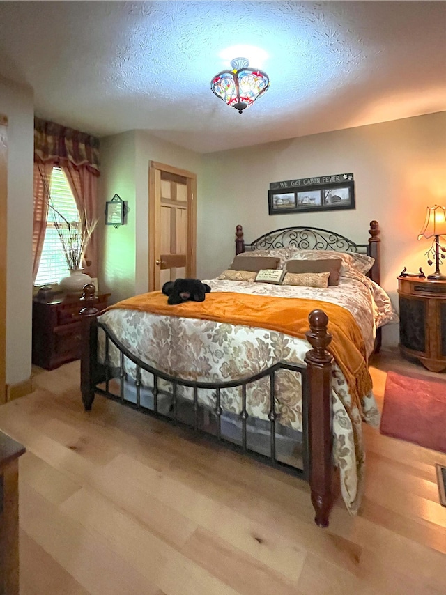 250 Hilltop Ests, Morehead, KY 40351 - bedroom with a textured ceiling and light wood-style floors