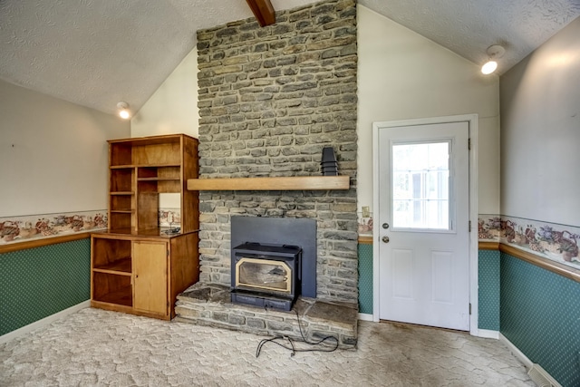560 Kemper Ln, Danville, KY 40422 - carpeted living room featuring lofted ceiling, a wood stove, a textured ceiling, and a wainscoted wall
