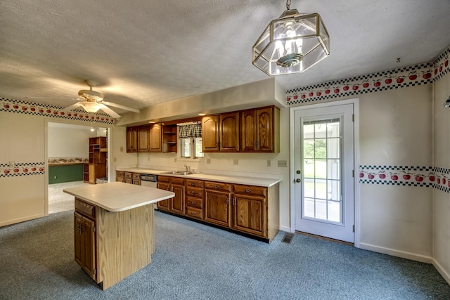 560 Kemper Ln, Danville, KY 40422 - kitchen featuring light countertops, carpet, brown cabinets, a ceiling fan, and a kitchen island