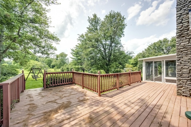 560 Kemper Ln, Danville, KY 40422 - wooden terrace featuring a playground, view of wooded area, and a lawn