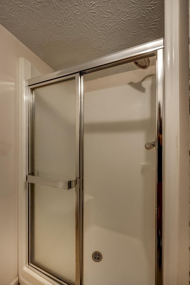 560 Kemper Ln, Danville, KY 40422 - bathroom featuring a stall shower and a textured ceiling