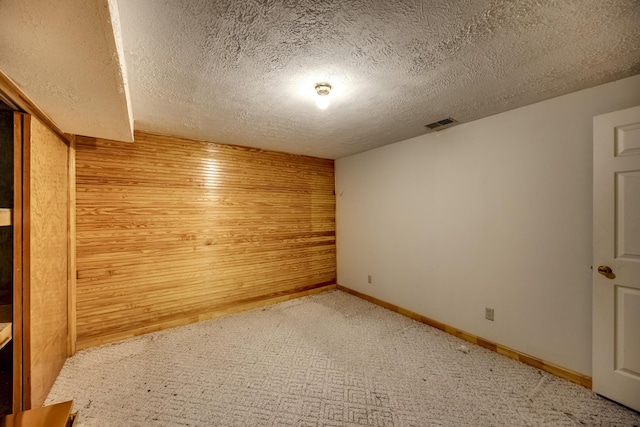 560 Kemper Ln, Danville, KY 40422 - unfurnished room featuring a textured ceiling, light colored carpet, and wooden walls