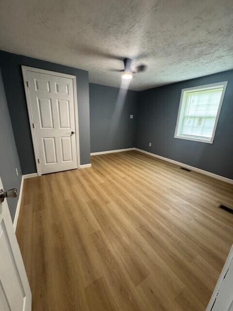 524 Clark St, Danville, KY 40422 - unfurnished bedroom featuring wood finished floors, a textured ceiling, and ceiling fan