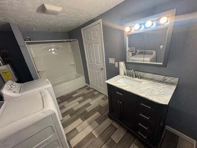 524 Clark St, Danville, KY 40422 - full bathroom with separate washer and dryer, vanity, wood finished floors, and a textured ceiling