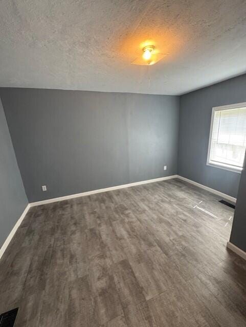 524 Clark St, Danville, KY 40422 - spare room featuring wood finished floors and a textured ceiling