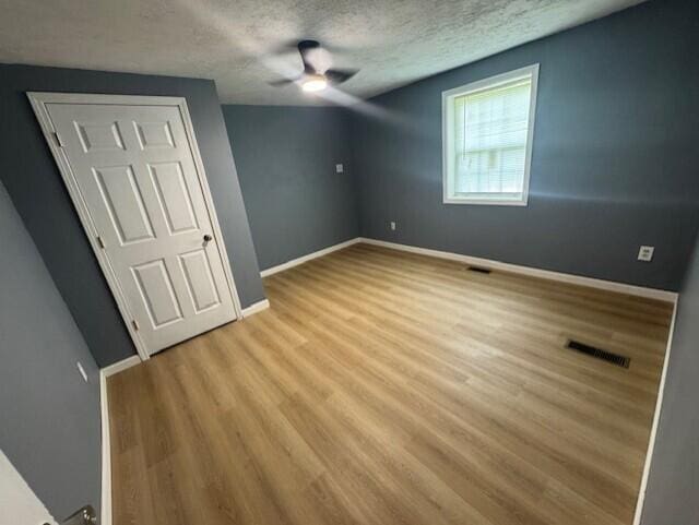 524 Clark St, Danville, KY 40422 - unfurnished bedroom featuring wood finished floors, a textured ceiling, and ceiling fan