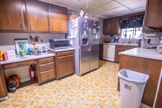 1181 Tracy Rd, Lawrenceburg, KY 40342 - kitchen with stainless steel appliances, light countertops, light flooring, a drop ceiling, and brown cabinets