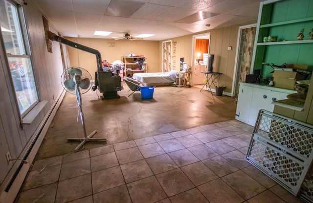 1181 Tracy Rd, Lawrenceburg, KY 40342 - basement with a baseboard radiator, ceiling fan, wood walls, and washer / clothes dryer