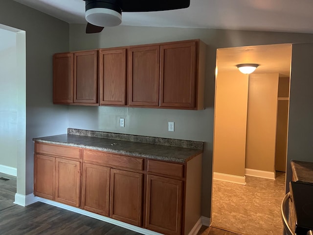 2441 Rogers Rd, Lancaster, KY 40444 - kitchen featuring a ceiling fan, dark countertops, brown cabinetry, and range with electric cooktop
