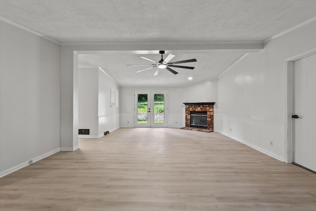 4822 US Highway 27 N, Cynthiana, KY 41031 - unfurnished living room featuring a textured ceiling, light wood-style flooring, a ceiling fan, ornamental molding, and a fireplace