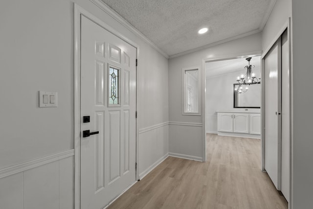 4822 US Highway 27 N, Cynthiana, KY 41031 - corridor featuring a textured ceiling, ornamental molding, light wood-type flooring, a chandelier, and a decorative wall