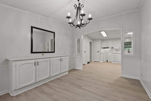 4822 US Highway 27 N, Cynthiana, KY 41031 - unfurnished dining area featuring a textured ceiling, a chandelier, light wood-type flooring, and crown molding