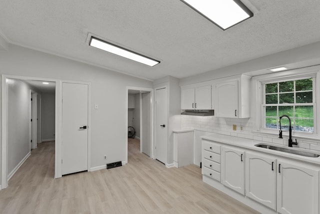 4822 US Highway 27 N, Cynthiana, KY 41031 - kitchen featuring vaulted ceiling, light wood-style floors, a textured ceiling, white cabinetry, and decorative backsplash