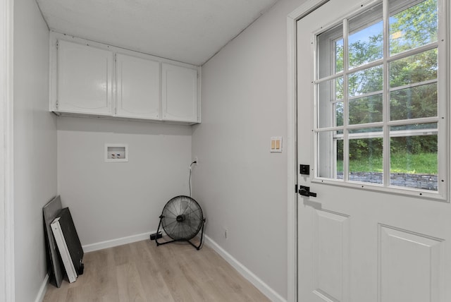 4822 US Highway 27 N, Cynthiana, KY 41031 - laundry area featuring cabinet space, hookup for a washing machine, light wood-style floors, and plenty of natural light