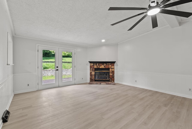 4822 US Highway 27 N, Cynthiana, KY 41031 - unfurnished living room with crown molding, a textured ceiling, wainscoting, light wood-type flooring, and french doors
