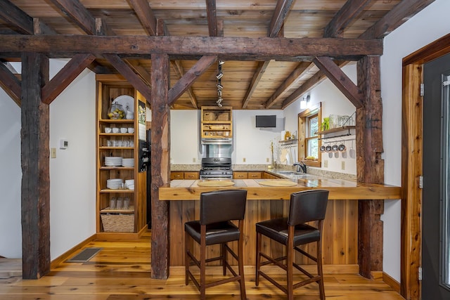 224 Pine Valley Rd, Berea, KY 40403 - bar area featuring stainless steel range with gas cooktop, light wood finished floors, a wood ceiling with exposed beams, and exhaust hood