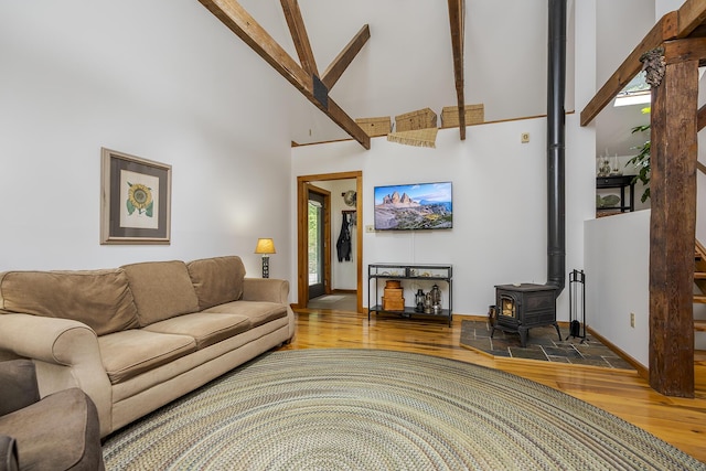 224 Pine Valley Rd, Berea, KY 40403 - living area with wood finished floors, a high ceiling, a wood stove, and plenty of natural light