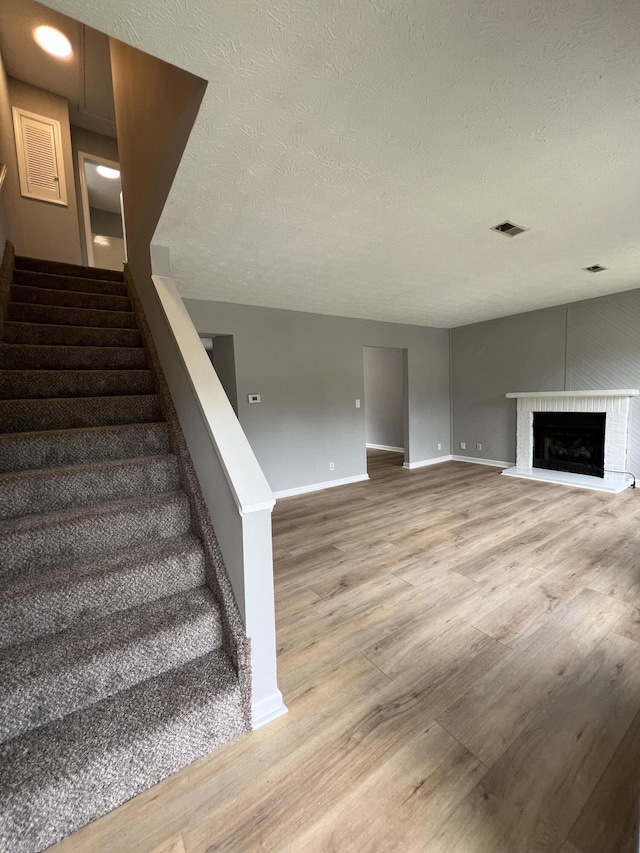 20 Heather Ln, Winchester, KY 40391 - stairway featuring wood finished floors, a textured ceiling, and a fireplace
