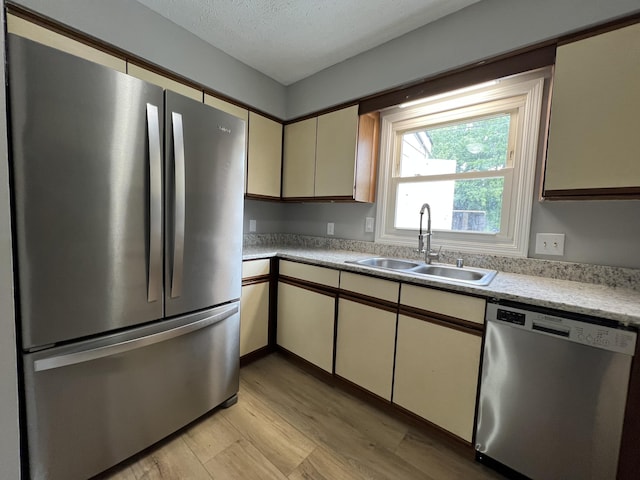 20 Heather Ln, Winchester, KY 40391 - kitchen with appliances with stainless steel finishes, light wood-type flooring, light countertops, cream cabinetry, and a textured ceiling