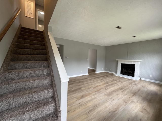 20 Heather Ln, Winchester, KY 40391 - stairs featuring wood finished floors, a fireplace, and a textured ceiling