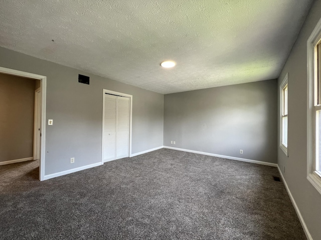20 Heather Ln, Winchester, KY 40391 - unfurnished bedroom with a textured ceiling, dark carpet, and a closet