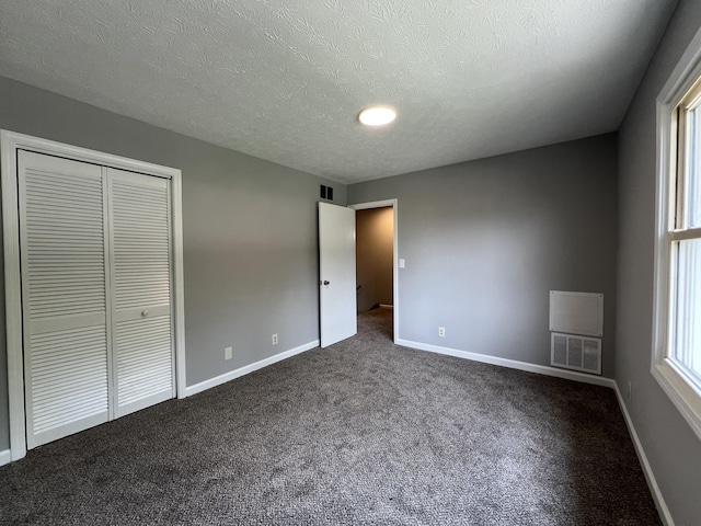 20 Heather Ln, Winchester, KY 40391 - unfurnished bedroom featuring dark carpet, a closet, and a textured ceiling