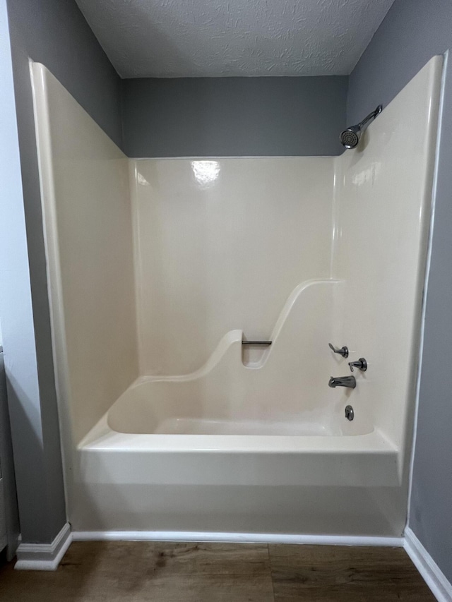 20 Heather Ln, Winchester, KY 40391 - bathroom featuring shower / bath combination, a textured ceiling, and wood finished floors