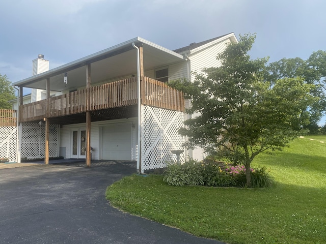 5515 Van Meter Rd, Winchester, KY 40391 - view of front of house featuring an attached garage, a front lawn, a chimney, and asphalt driveway
