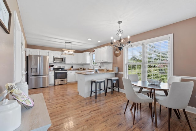 313 Man O War Ct, Lawrenceburg, KY 40342 - dining room with a chandelier, light wood finished floors, and recessed lighting
