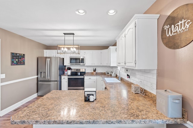 313 Man O War Ct, Lawrenceburg, KY 40342 - kitchen featuring stainless steel appliances, white cabinets, a peninsula, tasteful backsplash, and recessed lighting