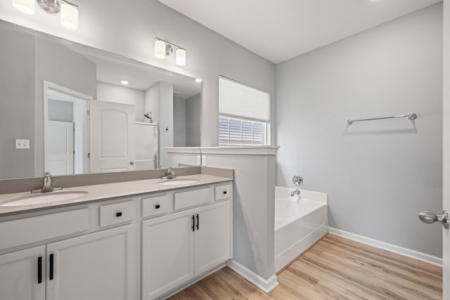 1152 Leanndra Park, Lexington, KY 40511 - bathroom with double vanity, wood finished floors, and a bath
