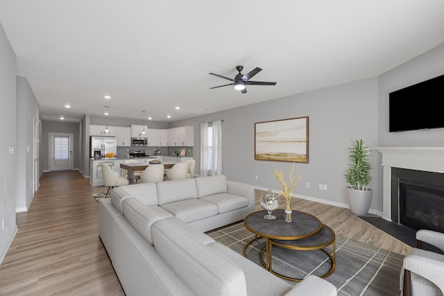 1152 Leanndra Park, Lexington, KY 40511 - living room featuring light wood finished floors, recessed lighting, a fireplace with flush hearth, and ceiling fan