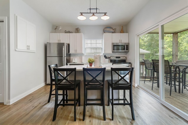 2394 Roberts Bend Rd, Burnside, KY 42519 - kitchen with appliances with stainless steel finishes, white cabinetry, and plenty of natural light