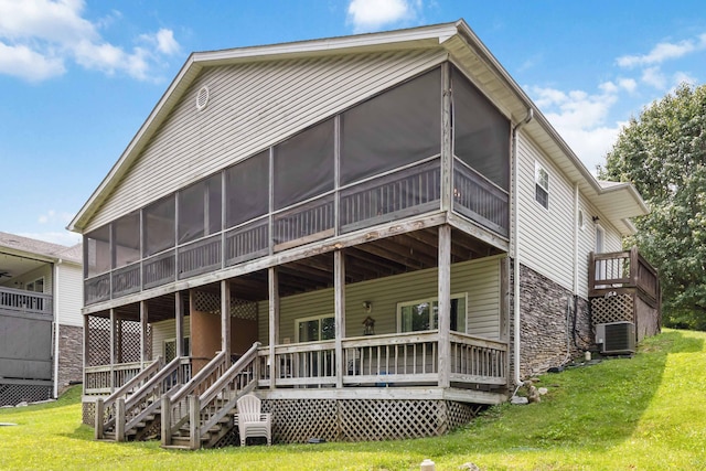 2394 Roberts Bend Rd, Burnside, KY 42519 - back of house featuring a sunroom, stone siding, and a yard