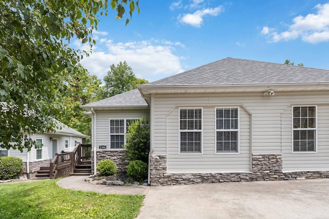 2394 Roberts Bend Rd, Burnside, KY 42519 - back of property with a shingled roof, a deck, and stone siding